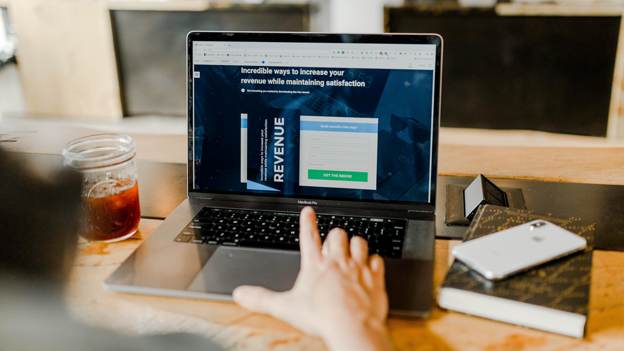 Man in front of laptop with landing page