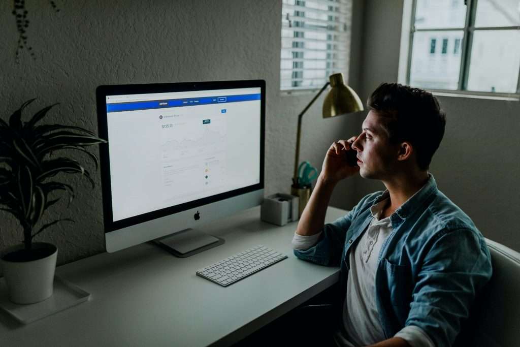 Marketer in front of computer, setting up a lead scoring system