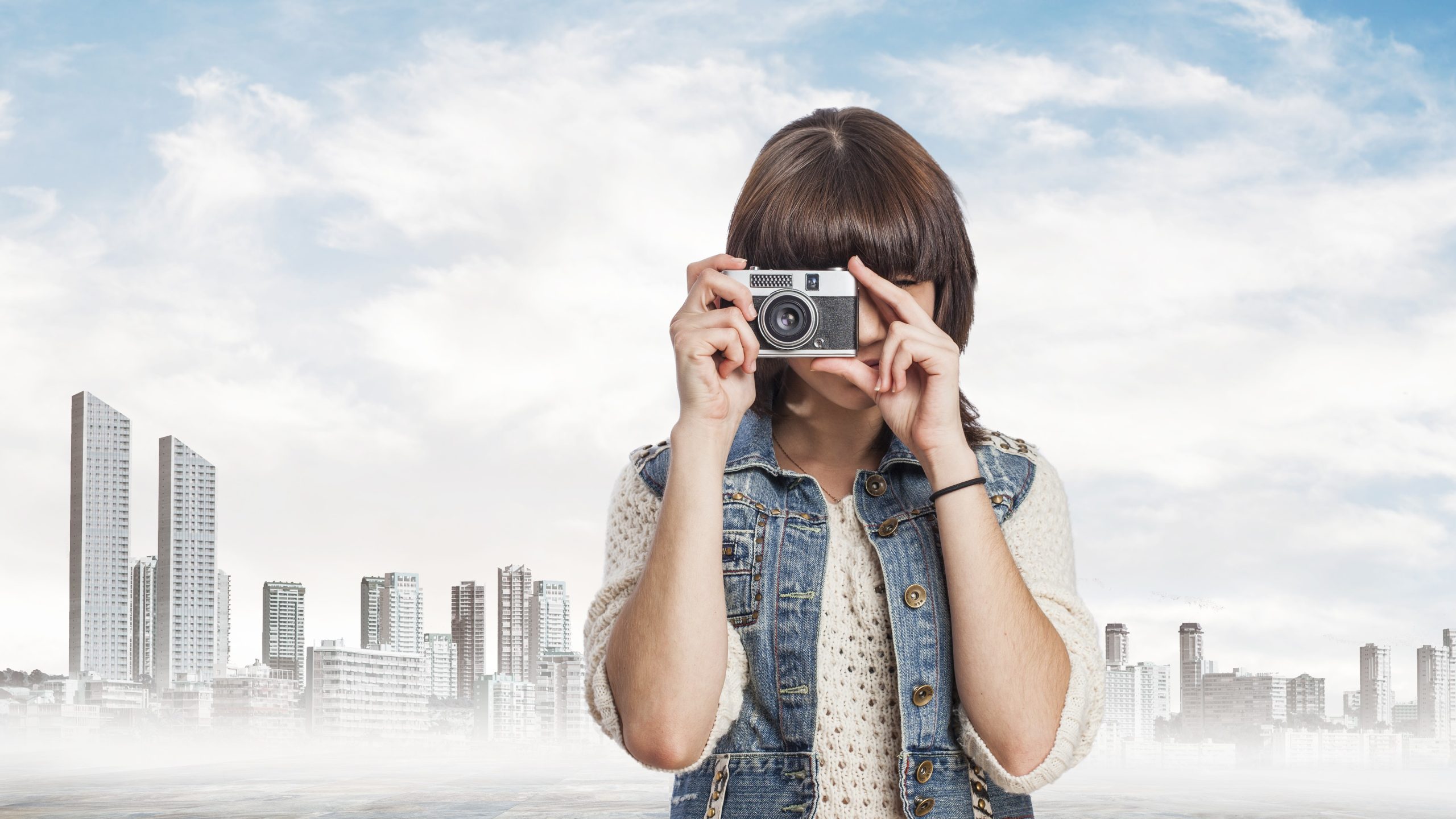 portrait of a pretty young woman taking a photo