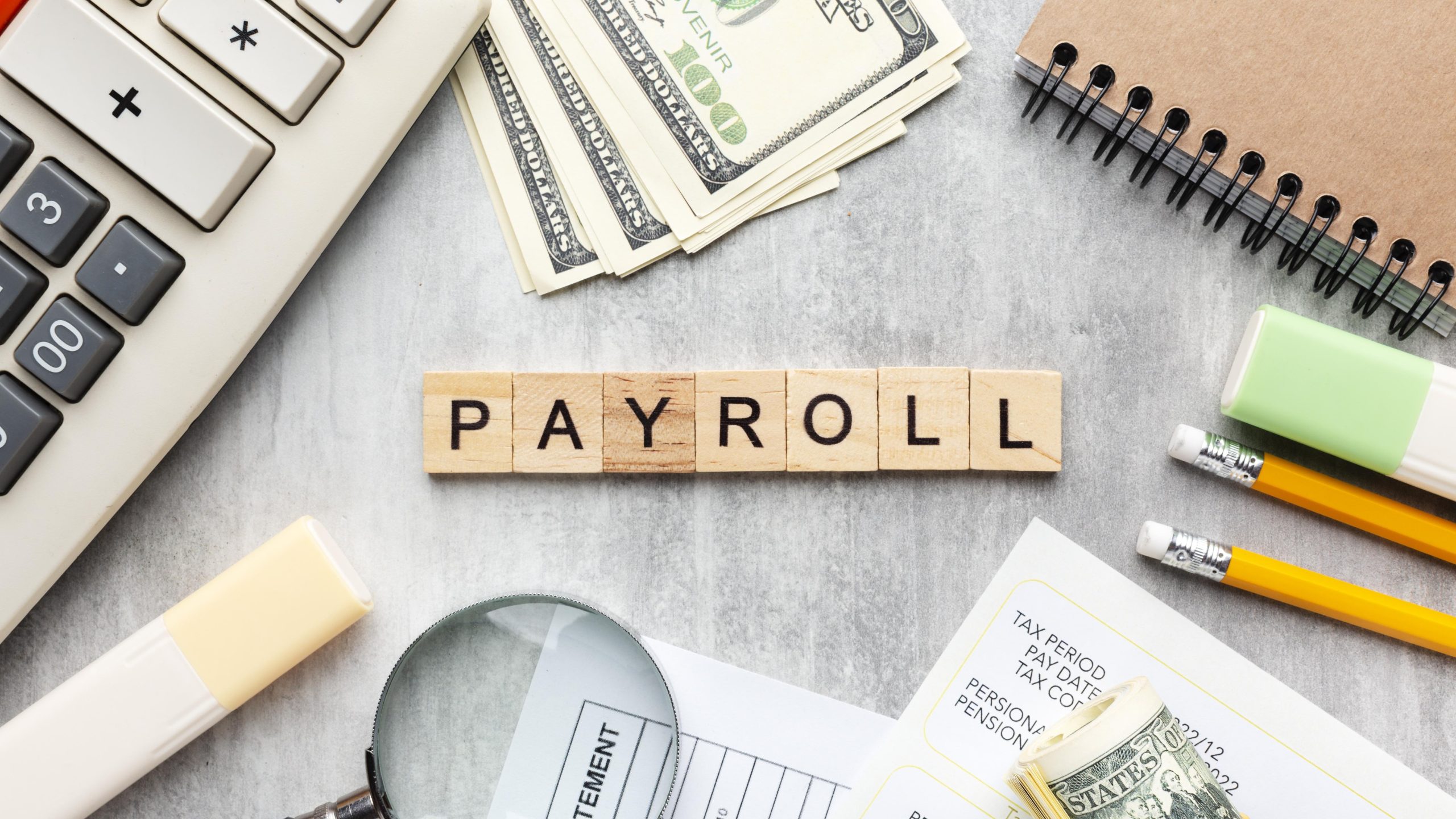 top-view-payroll-concept-with-items-scaled.jpg