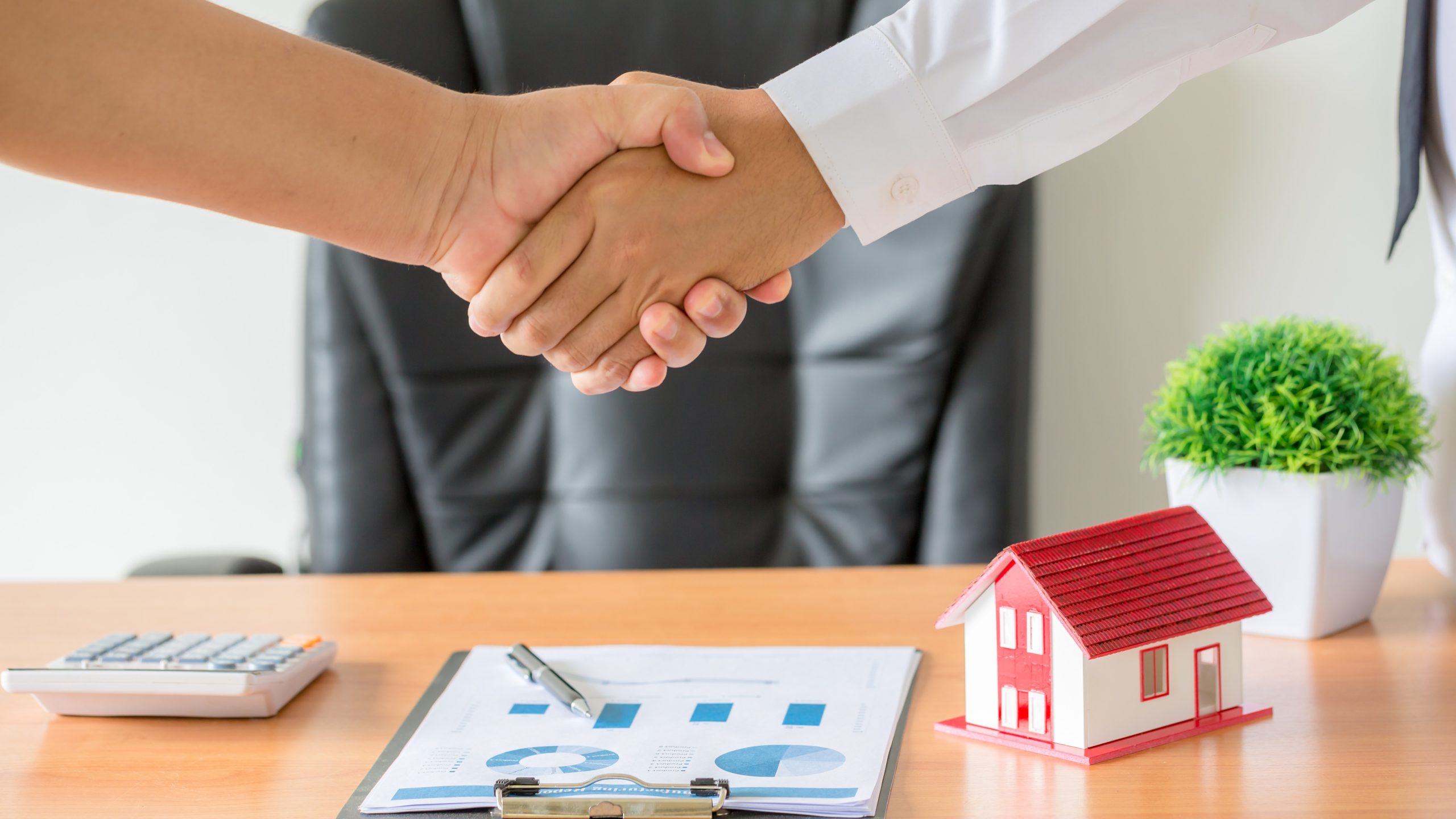 hands of agent and client shaking hands after signed contract buy new apartment.
